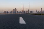 An empty highway leads towards the Burj Khalifa skyscraper, center, and other office buildings on the city skyline during the coronavirus lockdown in Dubai.