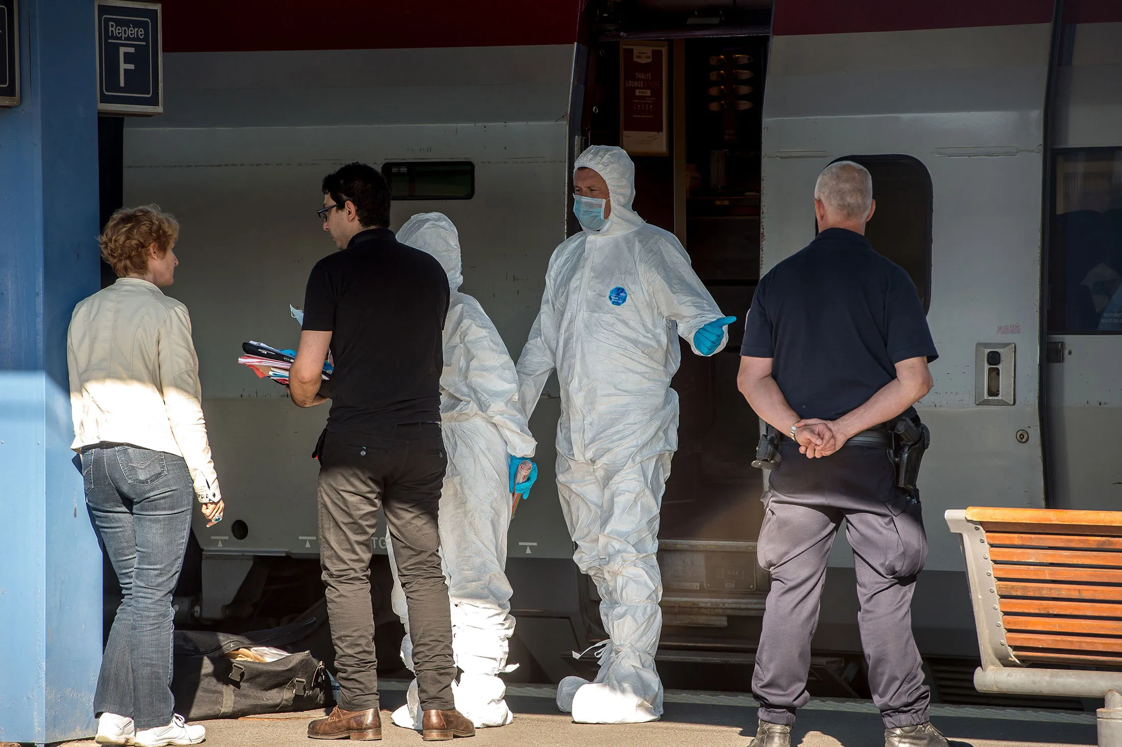 French forensics police officers inspect the crime scene in a Thalys train of French national railway operator SNCF at the main train station in Arras on August 22.
