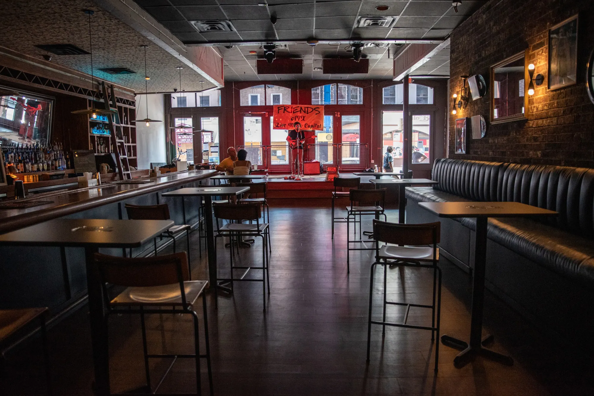A musician plays to a mostly empty bar in Austin, Texas on June 25.