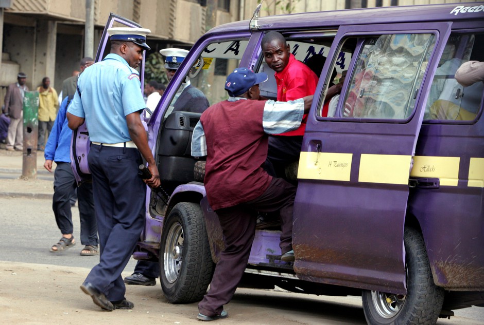 A Kenyan policeman boards a matatu after the vehicle was stopped for a traffic offense. “Every matatu driver has been in jail at least once,” says James Kariuki, a 20-year veteran of the industry.