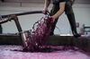 Jean-Etienne Alary, vintage intern for Henschke wines, monitors a pump over of juice to break up the top layer of berries in the open top fermentor of the 2018 Hill of Grace harvest at Henschke wine in the Eden Valley, South Australia, on Tuesday, Apr. 03, 2018.
