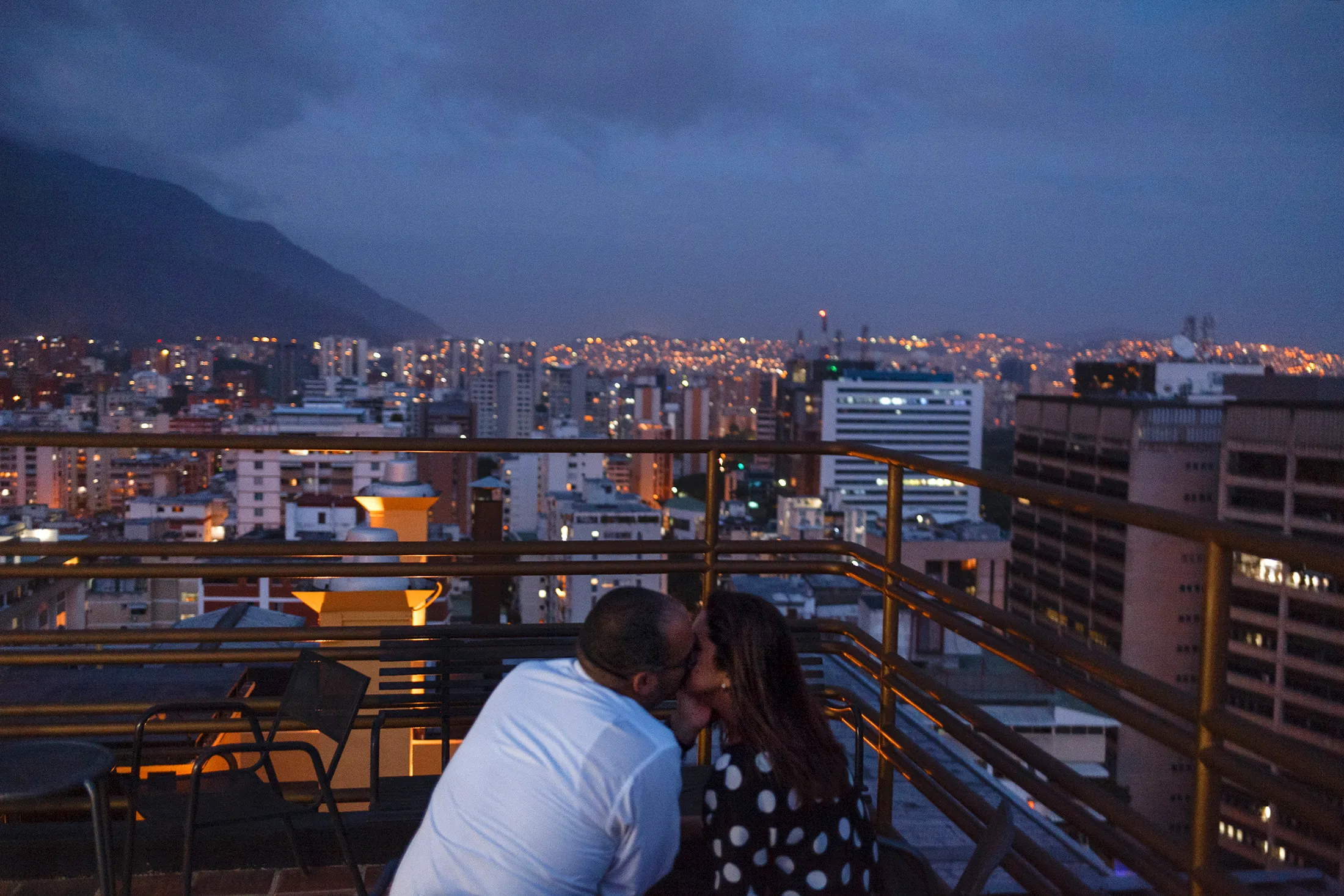 Romance at the 360 Caracas rooftop bar, overlooking the lights—which are on, for the moment—of the capital.
