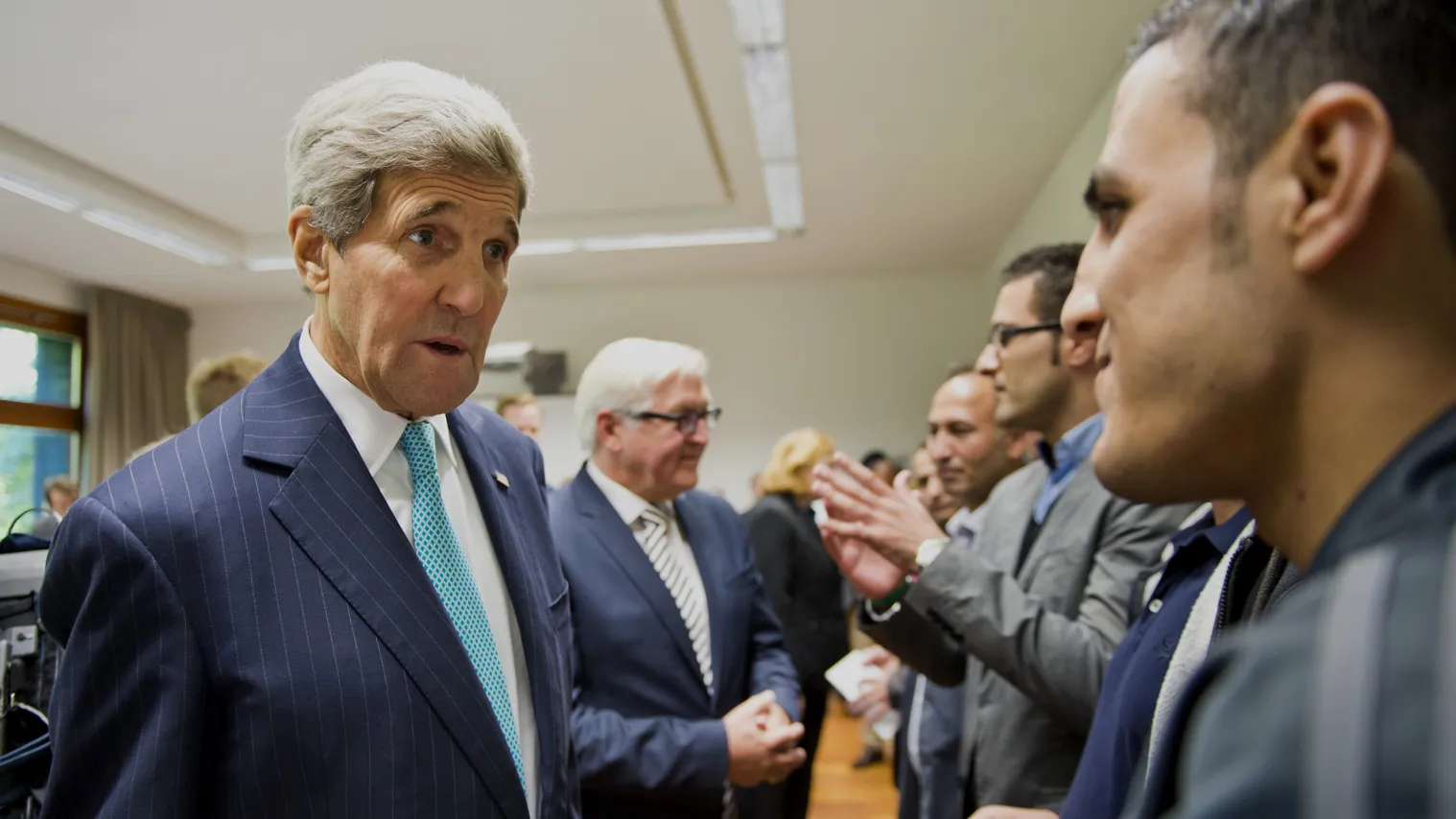 German Foreign Minister Frank-Walter Steinmeier and U.S. Secretary of State John Kerry meet with refugees from Syria.

