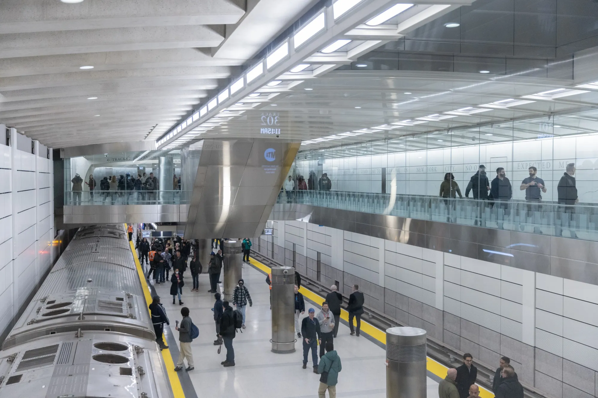Commuters walk on platform during the launch of the Long Island Rail Road terminal.