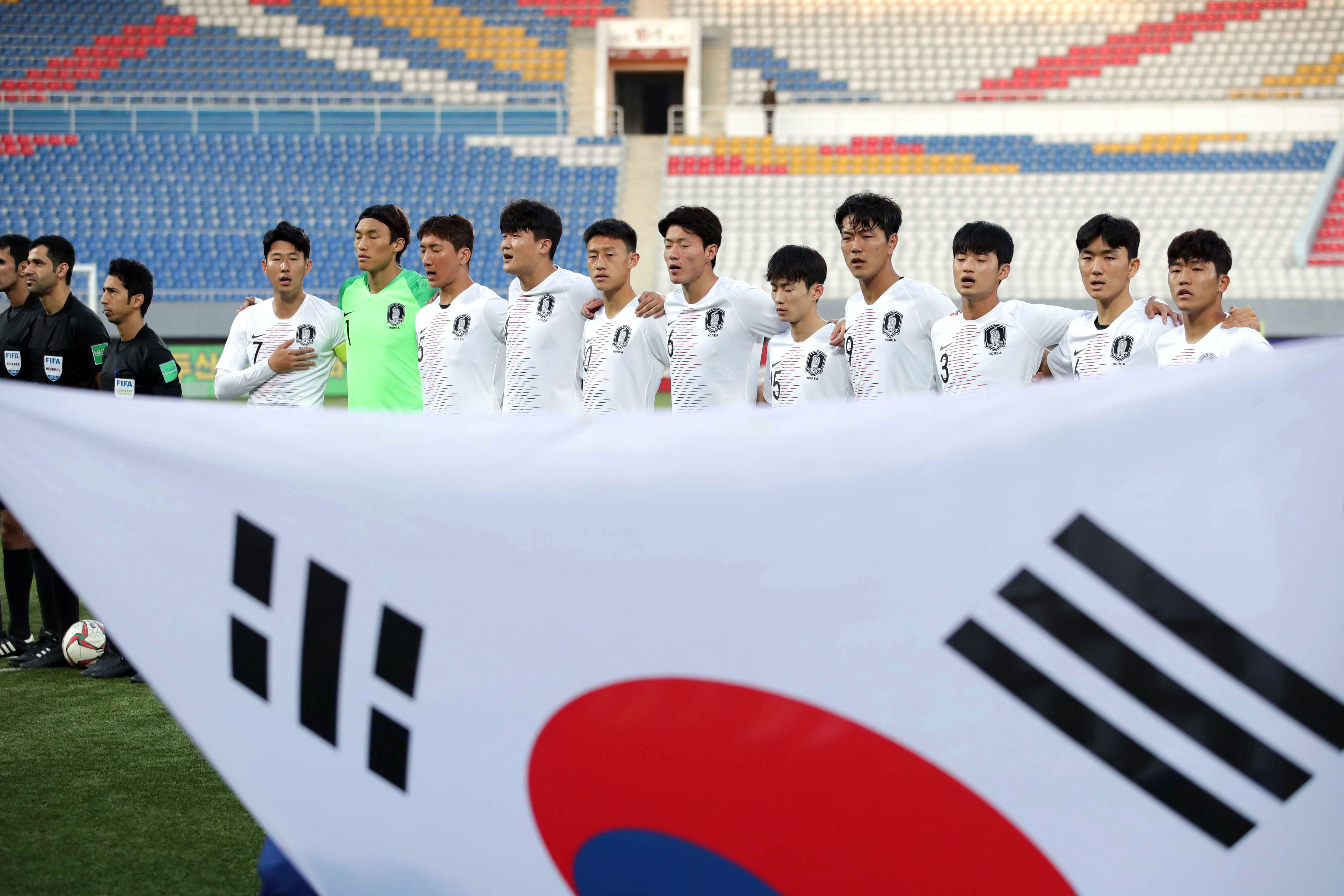 South Korean players stand for the national anthems prior to a match against North Korea, Oct. 14.