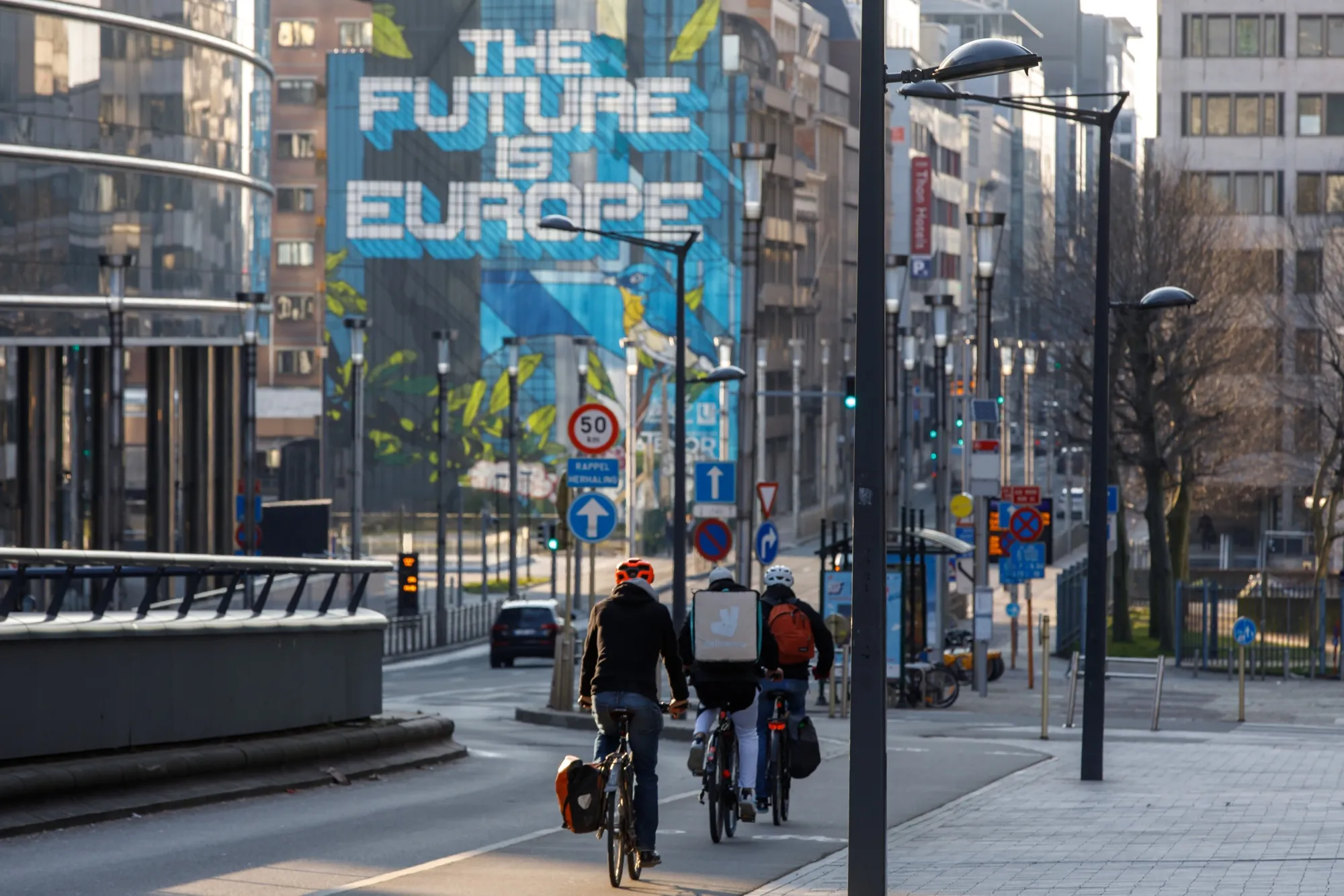 Bicyclists ride near the Berlaymont building in Brussels, Belgium.