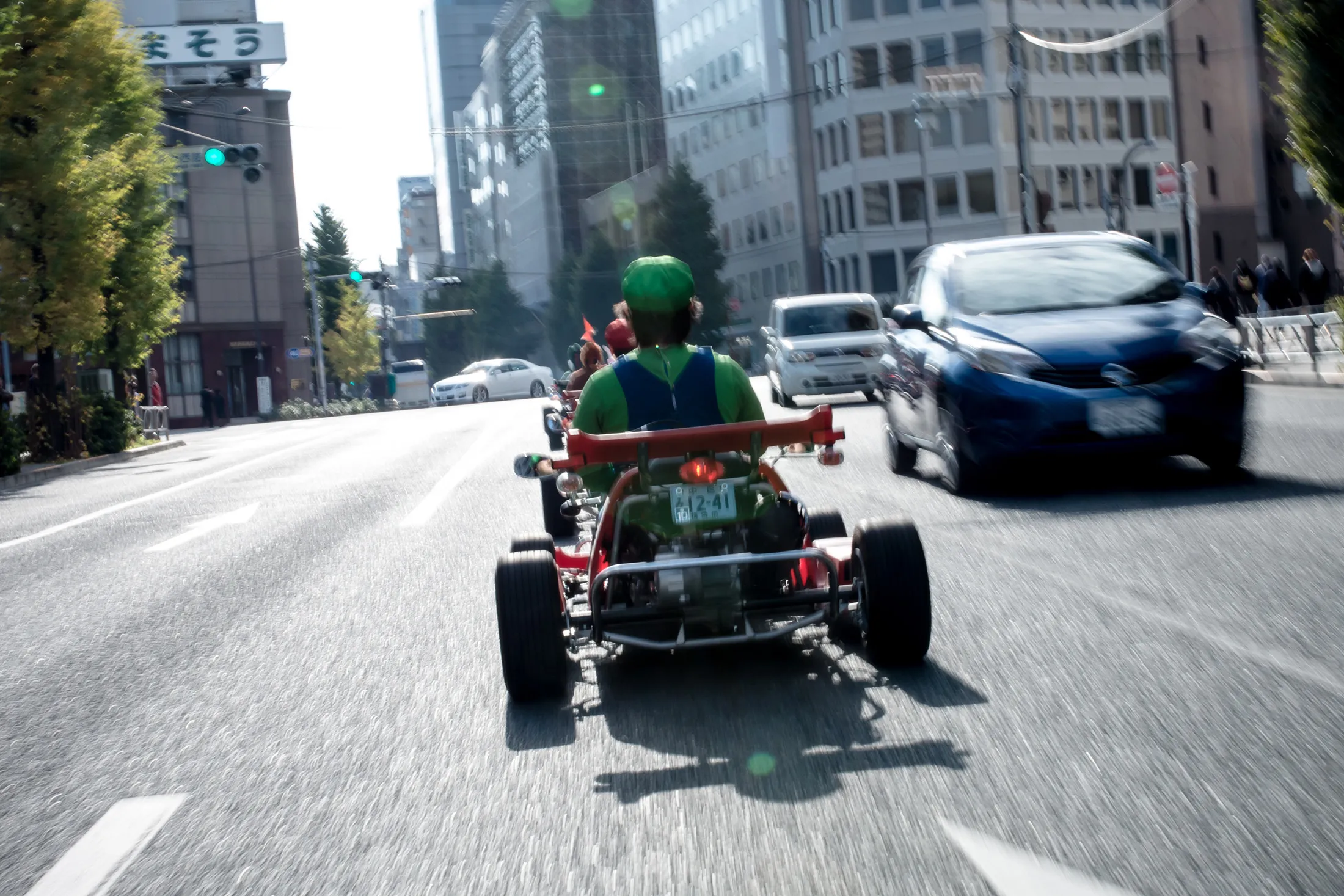TOKYO, JAPAN - NOVEMBER 16:  Participants drive around Tokyo in Mario Kart characters for the Real Mario Kart event in Tokyo on November 16, 2014 in Tokyo, Japan. The organizer calls for participants to this event held about once a month on Facebook, and Akiba Kart offers rental karts that can be driven on public streets.  (Photo by Keith Tsuji/Getty Images)