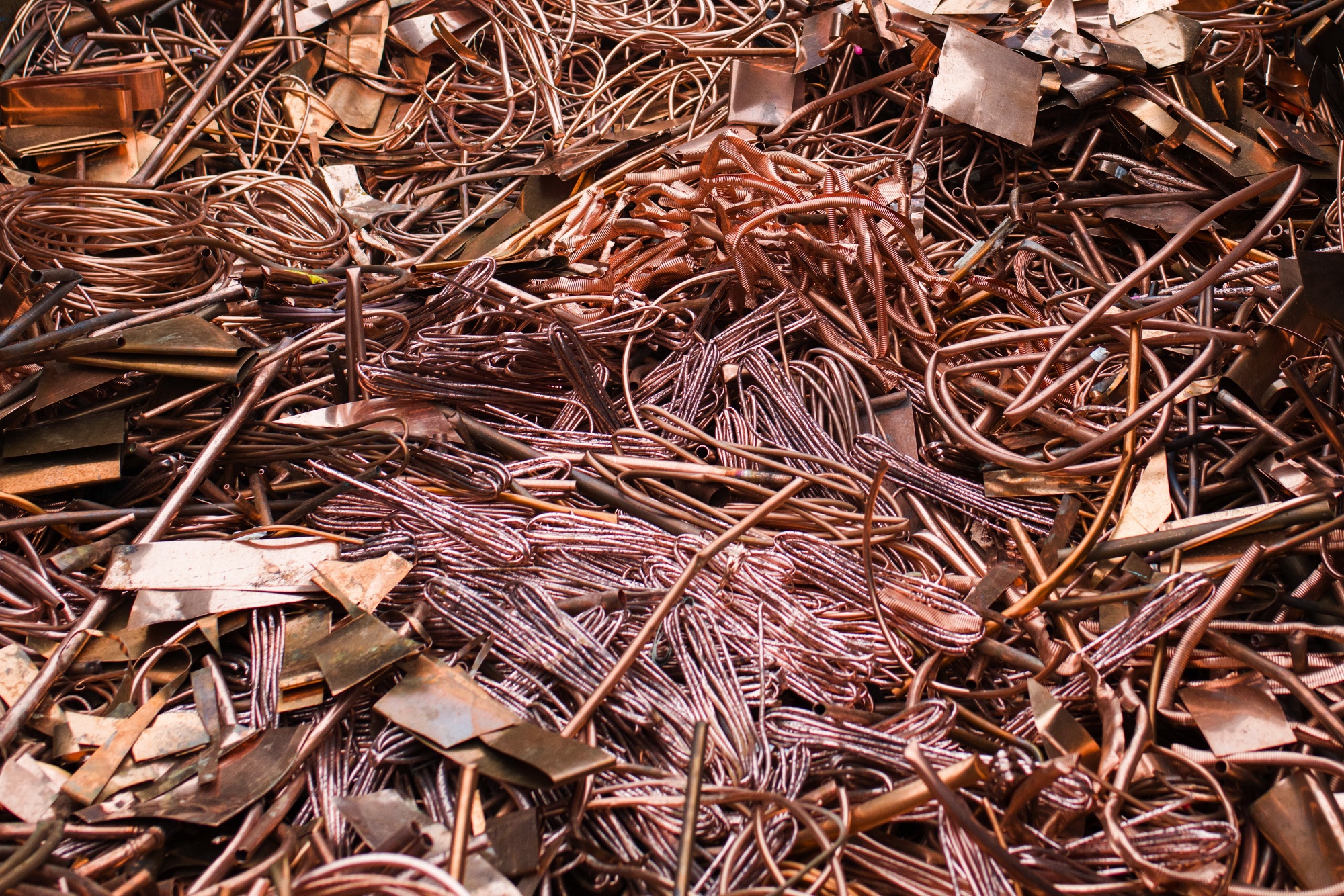 Pieces of copper cable and pipework at a scrap and metals recycling yard in Paris, France.