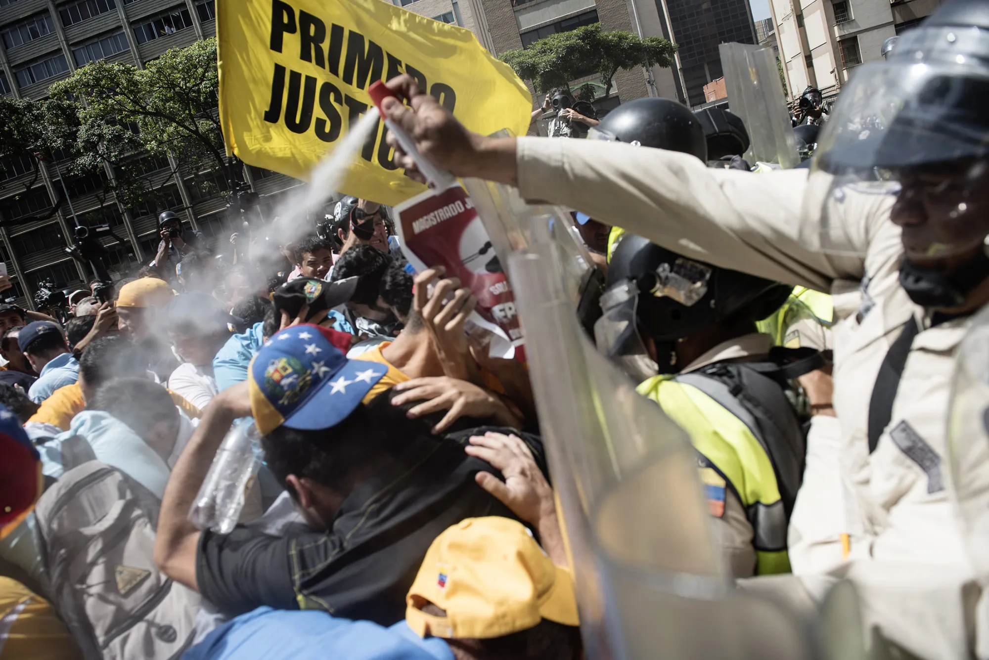 A National Guard officer uses pepper spray on demonstrators during an anti-government protest in Caracas, Venezuela, on April 4, 2017.
