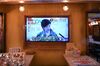 A television screen displays a news conference held by Tokyo Governor Yuriko Koike at a bar in the Shimbashi district of Tokyo, Japan. 