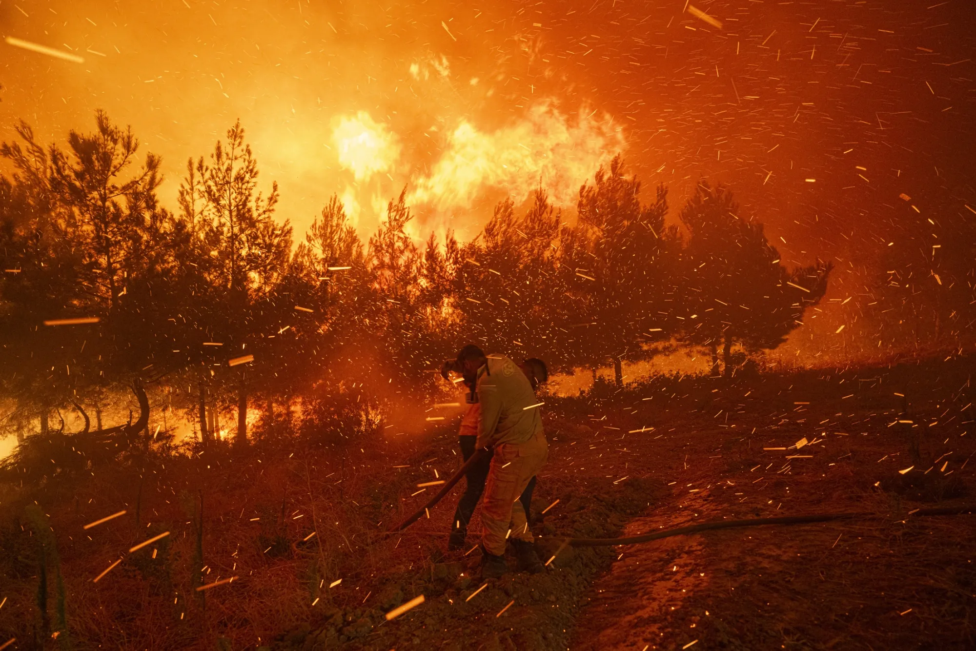 Firefighters tackle a wildfire in Canakkale, near the Dardanelles Strait, in Turkey, on Aug. 11.
