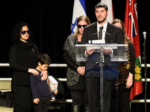 Jonathon Sherman speaks during the memorial service for his parents