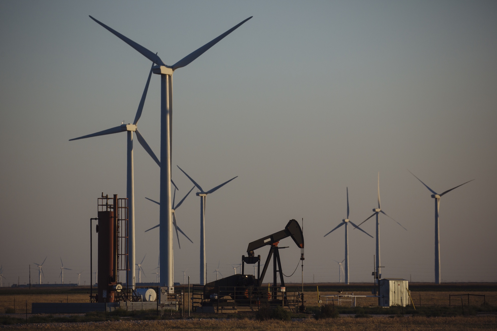 Wind turbines encircle a&nbsp;pump jack near Guymon, Oklahoma on&nbsp;Sept. 25, 2020.