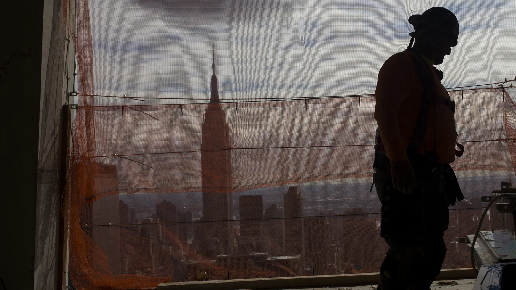 The Empire State building rises beyond a construction site in New York City.
