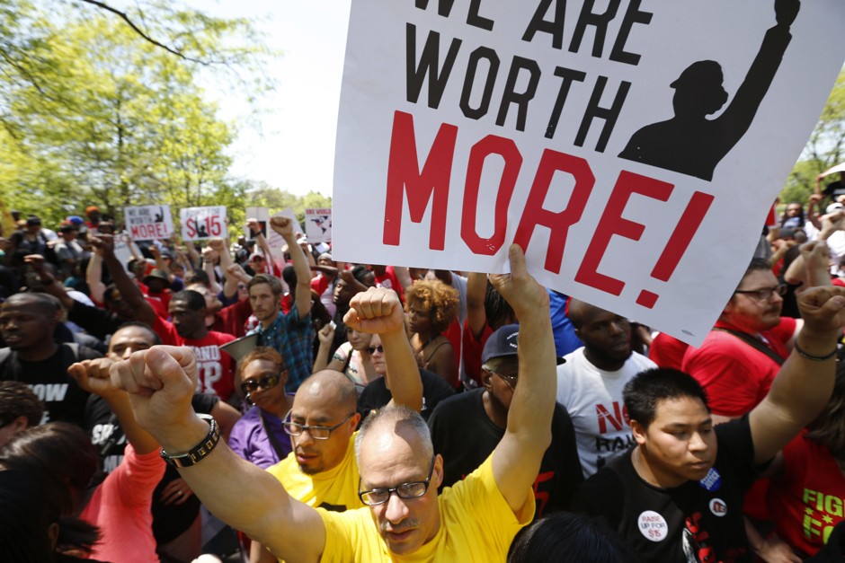 Workers demonstrate for a wage hike in front of McDonald's Illinois headquarters in May 2014