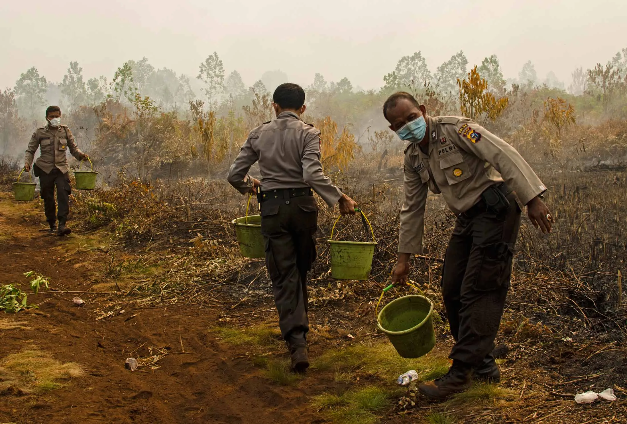 Indonesian police extinguish a fire in the Kampar District of Riau Province, Indonesia on Aug. 28, 2016.
