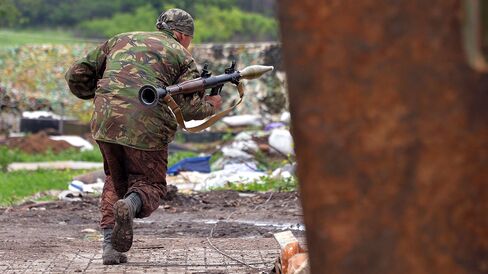 A Ukrainian serviceman prepares to fire a grenade launcher on positions on the frontline of fighting against pro-Russian separatists near Donetsk on May 30, 2015 in eastern Ukraine.
