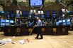 An employee cleans up trash on the floor of the New York Sto