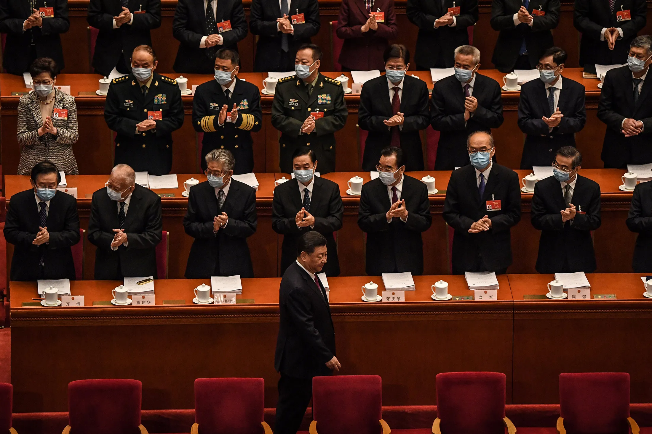 Delegates applaud as Xi Jinping arrives for the opening session of the NPC in Beijing on March 5.