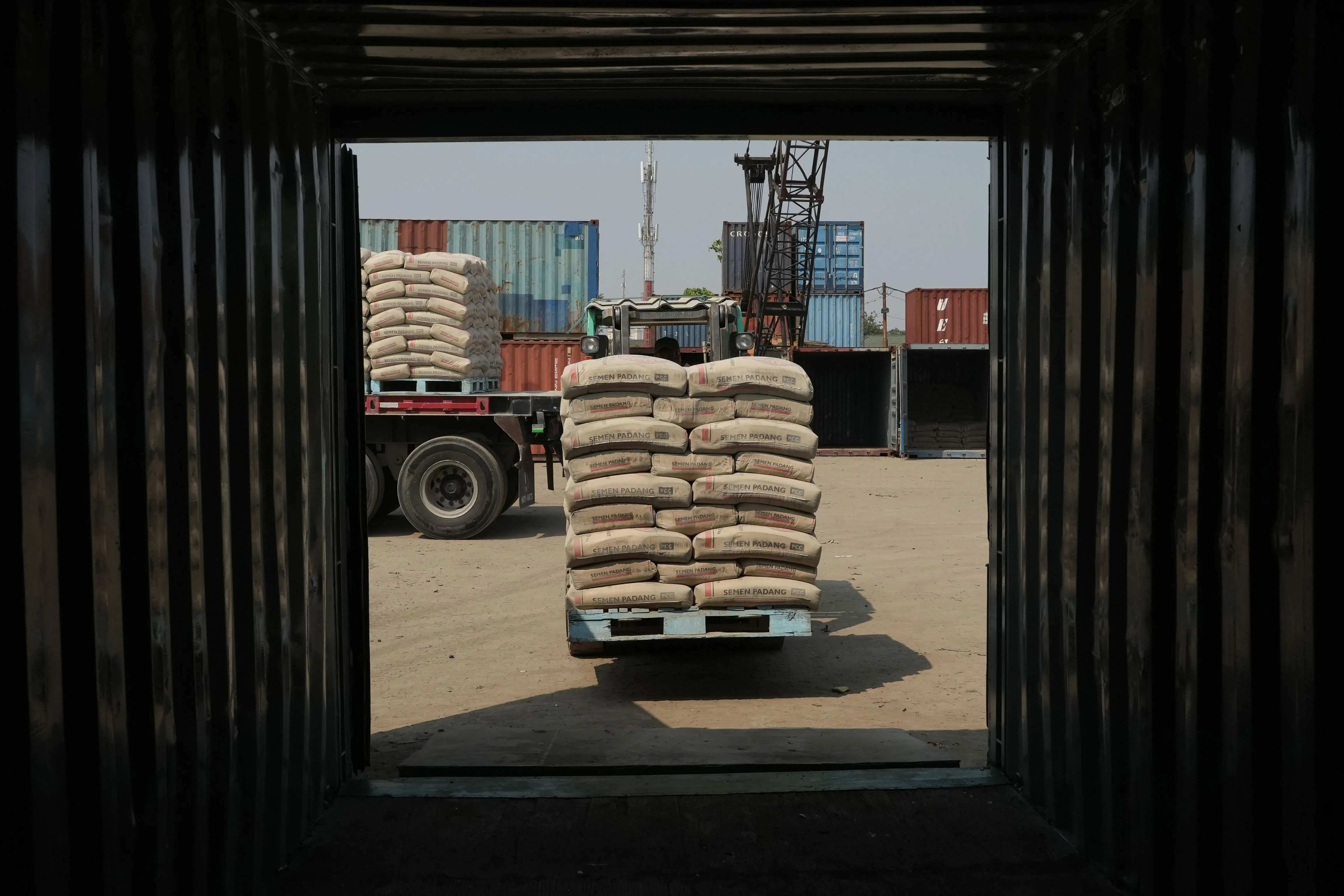 A worker uses a forklift to transport sacks of cement in Indonesia.&nbsp;