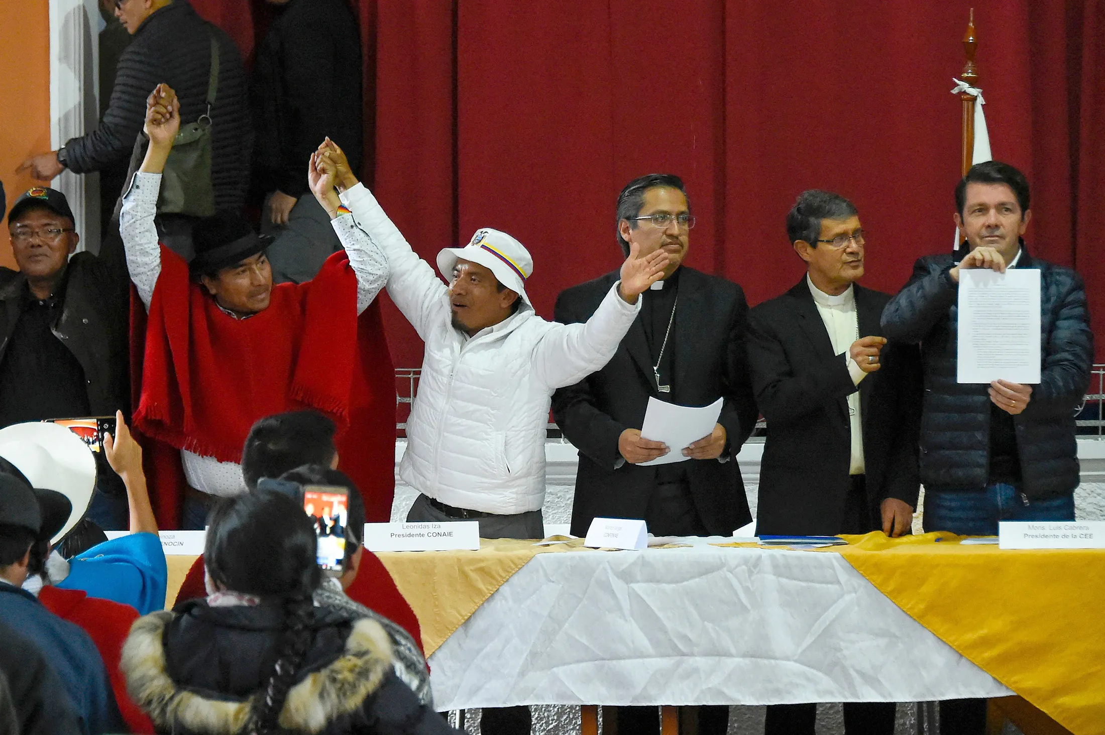 Francisco Jimenez, Ecuador’s government minister, right, and Leonidas Iza reach an agreement to end protests in Quito on June 30.