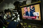 Donald Trump, speaking in a televised address from the Oval Office, is seen on a monitor in the briefing room of the White House in Washington, D.C., U.S., on March 11,