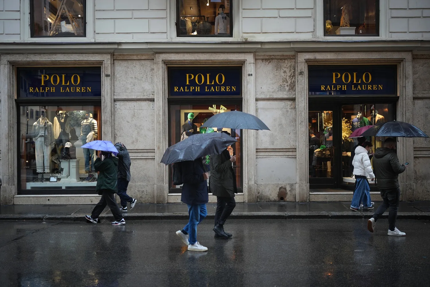 Shoppers and tourists walk past a Polo Ralph Lauren store in&nbsp;Rome.