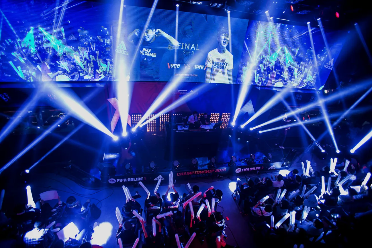 Fans cheer and wave batons as they watch the final round of the Electronic Arts Inc. (EA) Sports FIFA Online Championship at the Nexon Co. e-Sports Stadium in Seoul, South Korea, on Saturday, Oct. 17, 2015. Video game competitions, known as eSports, have been expanding as gamers seek to shift perceptions around their craft from a basement hobby to a serious money making industry.
