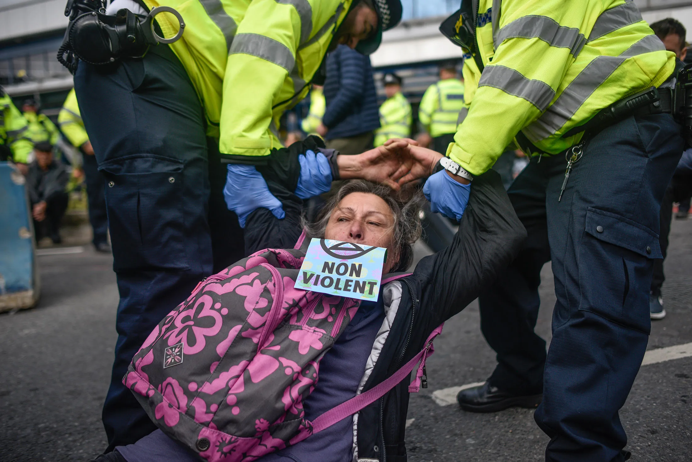 An activist is removed by police during a climate change protest at the London City Airport on Oct. 10.