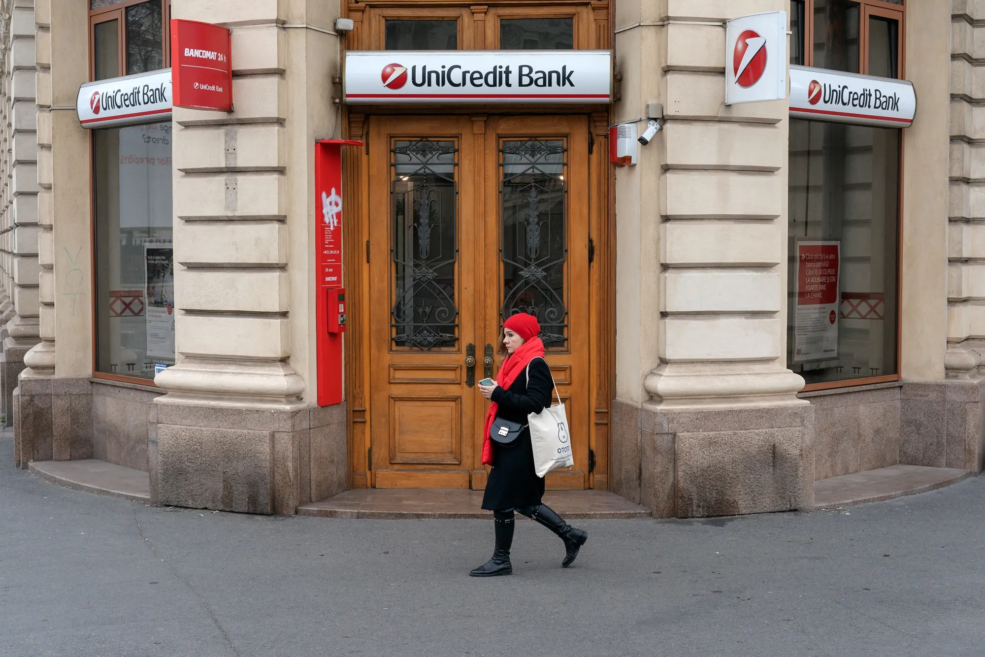 A pedestrian passes a UniCredit Bank&nbsp;branch in Bucharest.&nbsp;
