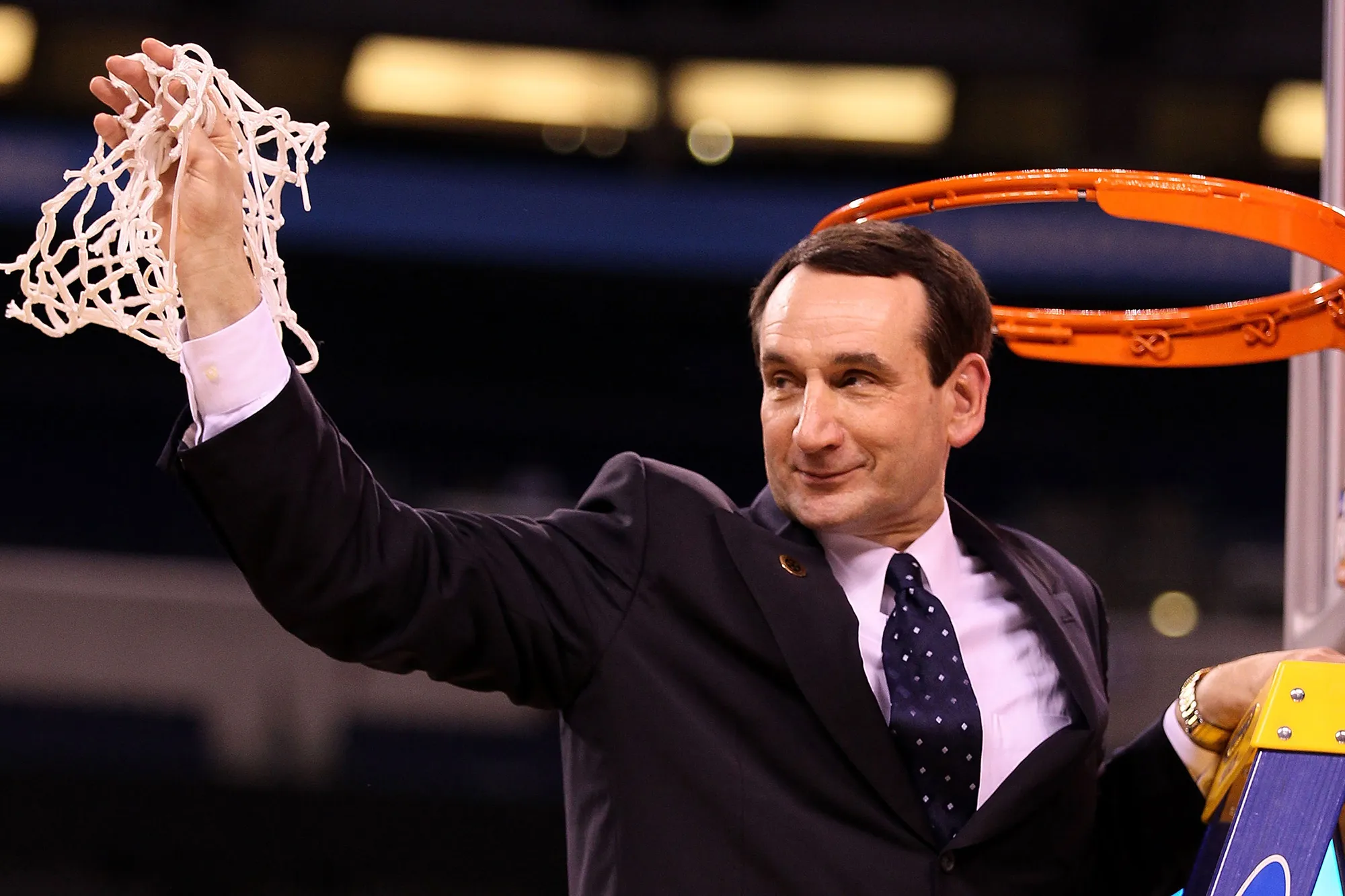 Mike Krzyzewski holds the net following his team's win during the 2010 NCAA Division I Men's Basketball National Championship game in Indianapolis, Indiana.