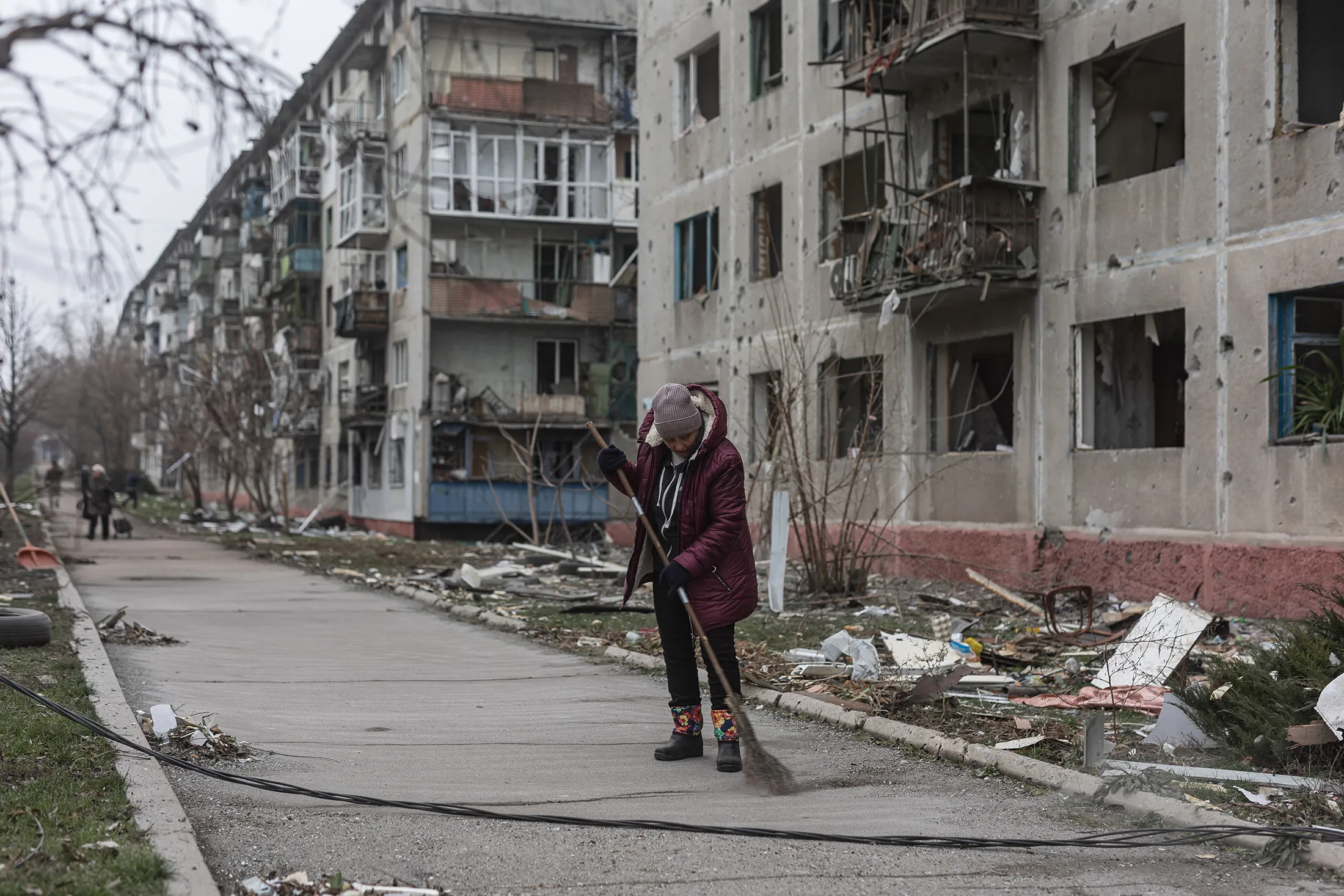 Residents of Druzhkivka, Ukraine, clear debris after a Russian shelling&nbsp;on Dec. 21.