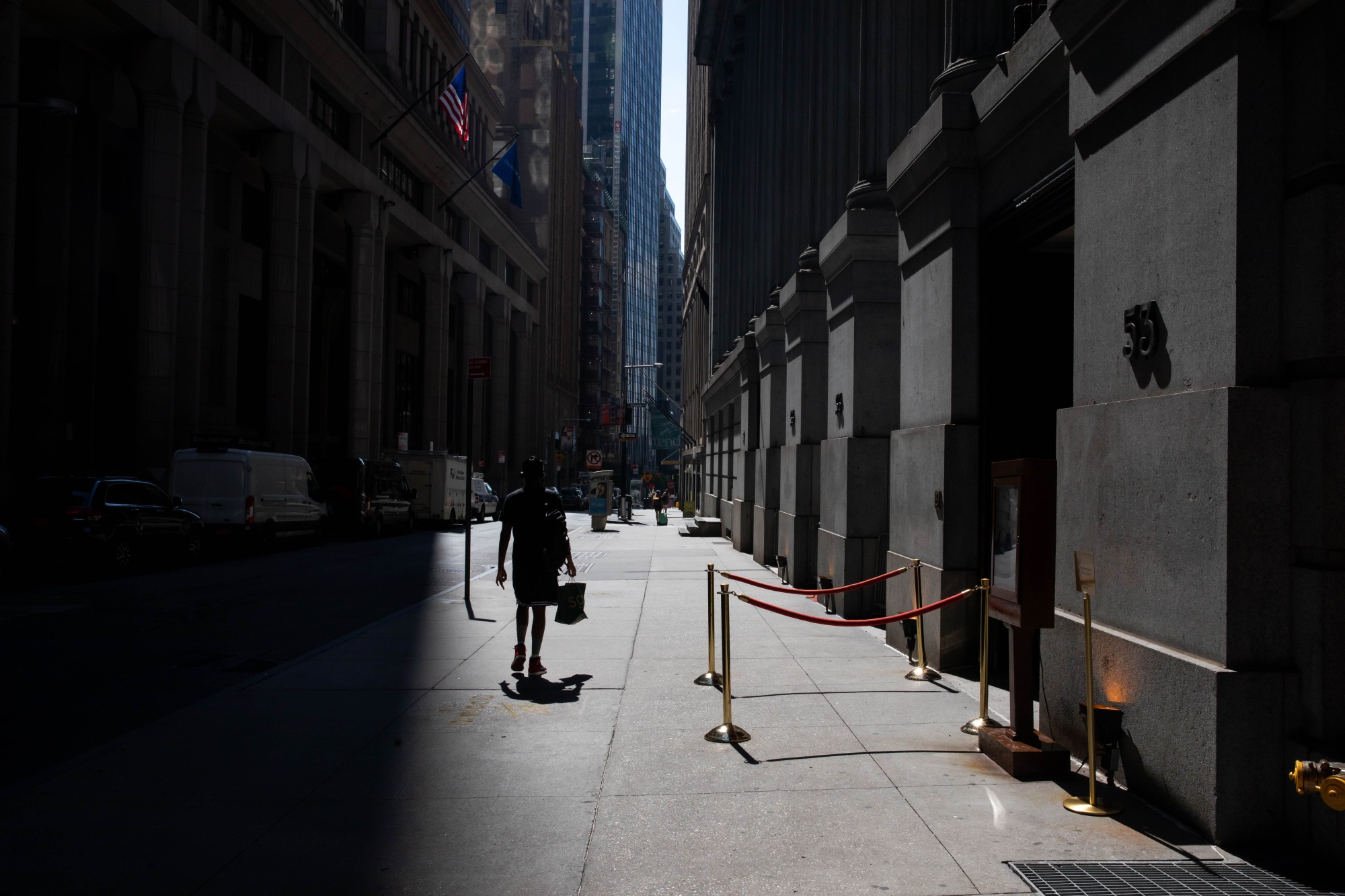 A pedestrian walks along Wall Street near the New York Stock Exchange on&nbsp;July 20, 2020.&nbsp;