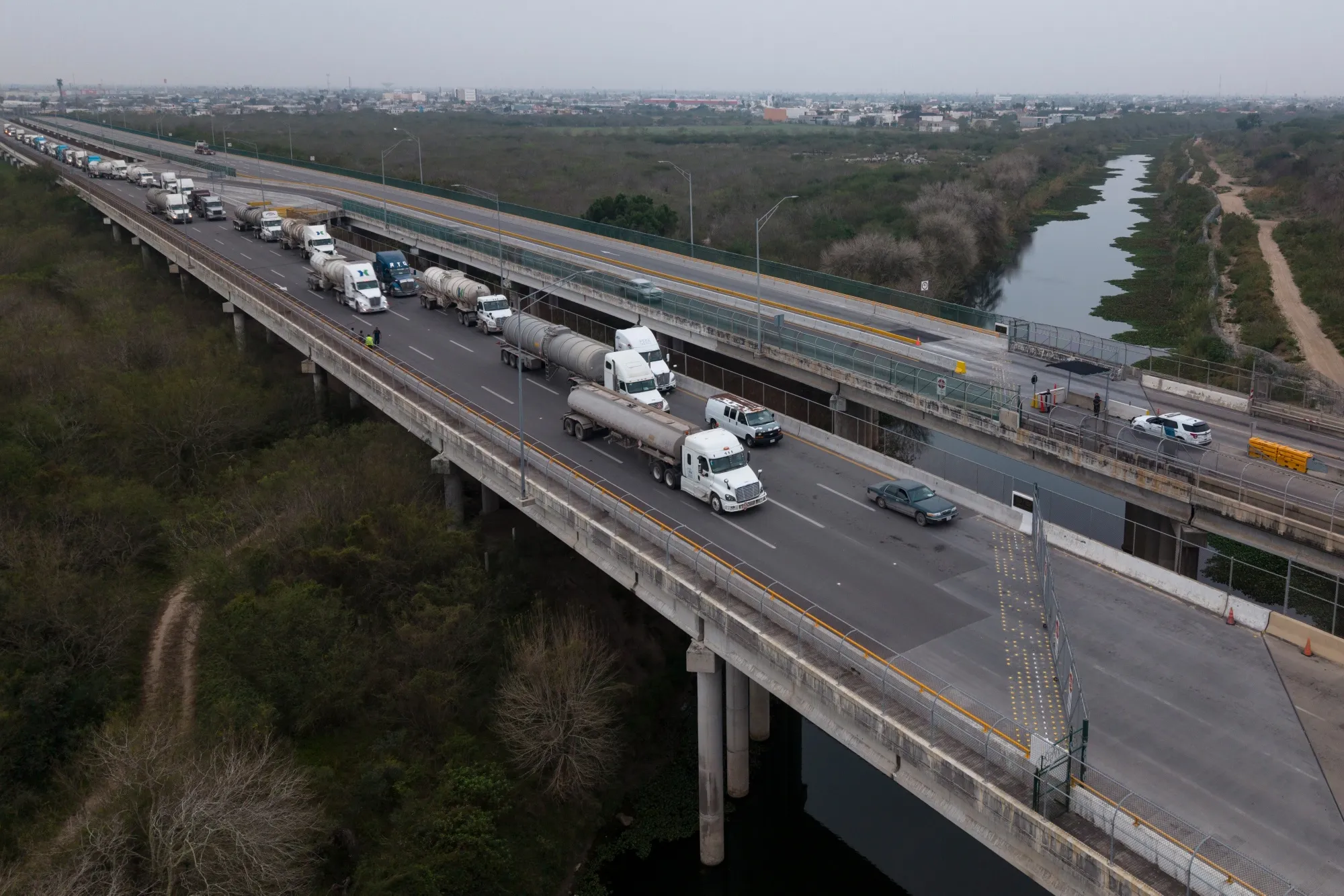 Trucks wait in line to enter the United States from Mexico at the Veterans-Los Tomates port of entry in Brownsville, Texas.