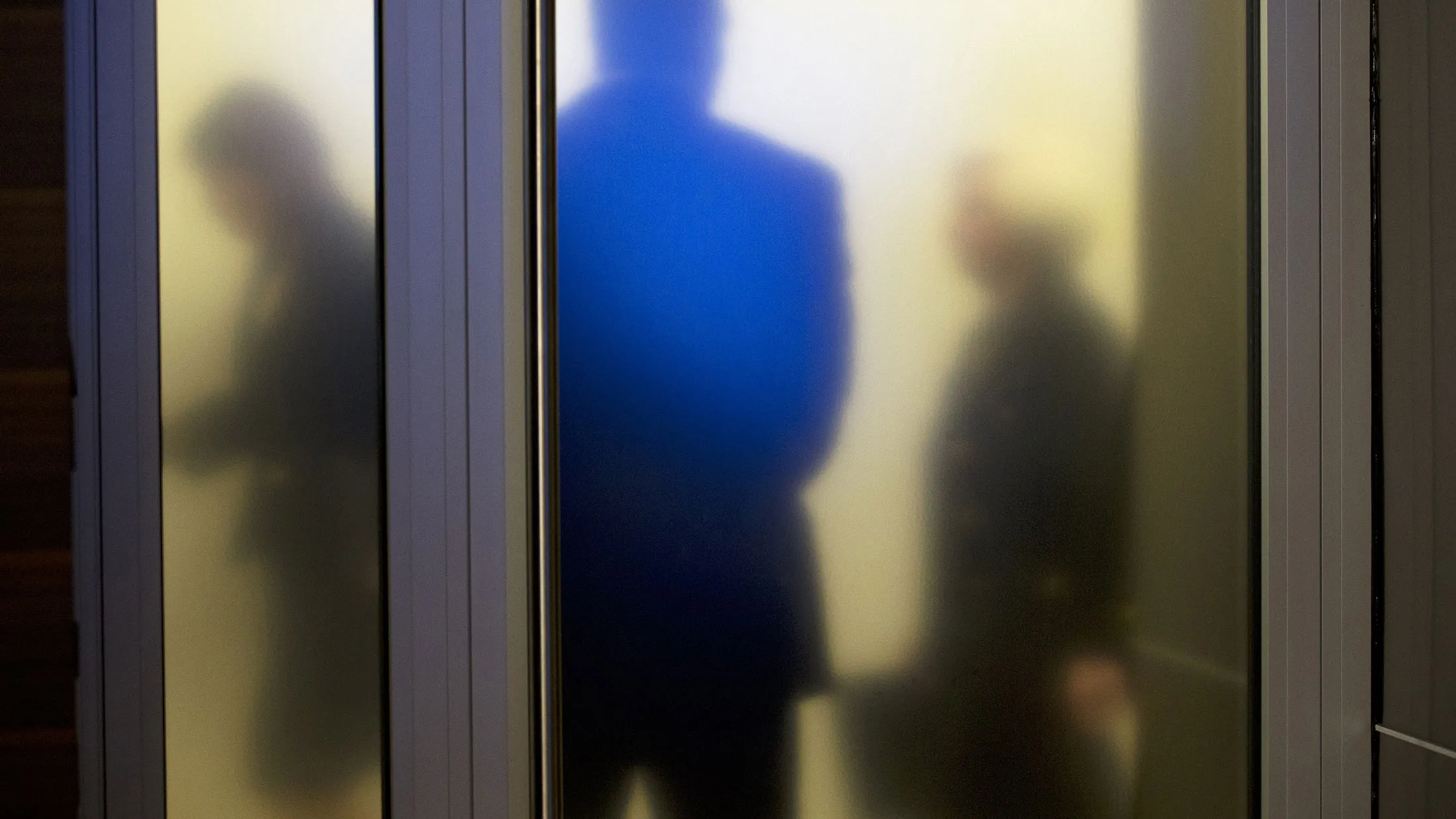 Federal Reserve Chair Janet Yellen, right, walks past a frosted glass door as she arrives to speak at a news conference in Washington, on Sept. 17, 2015.
