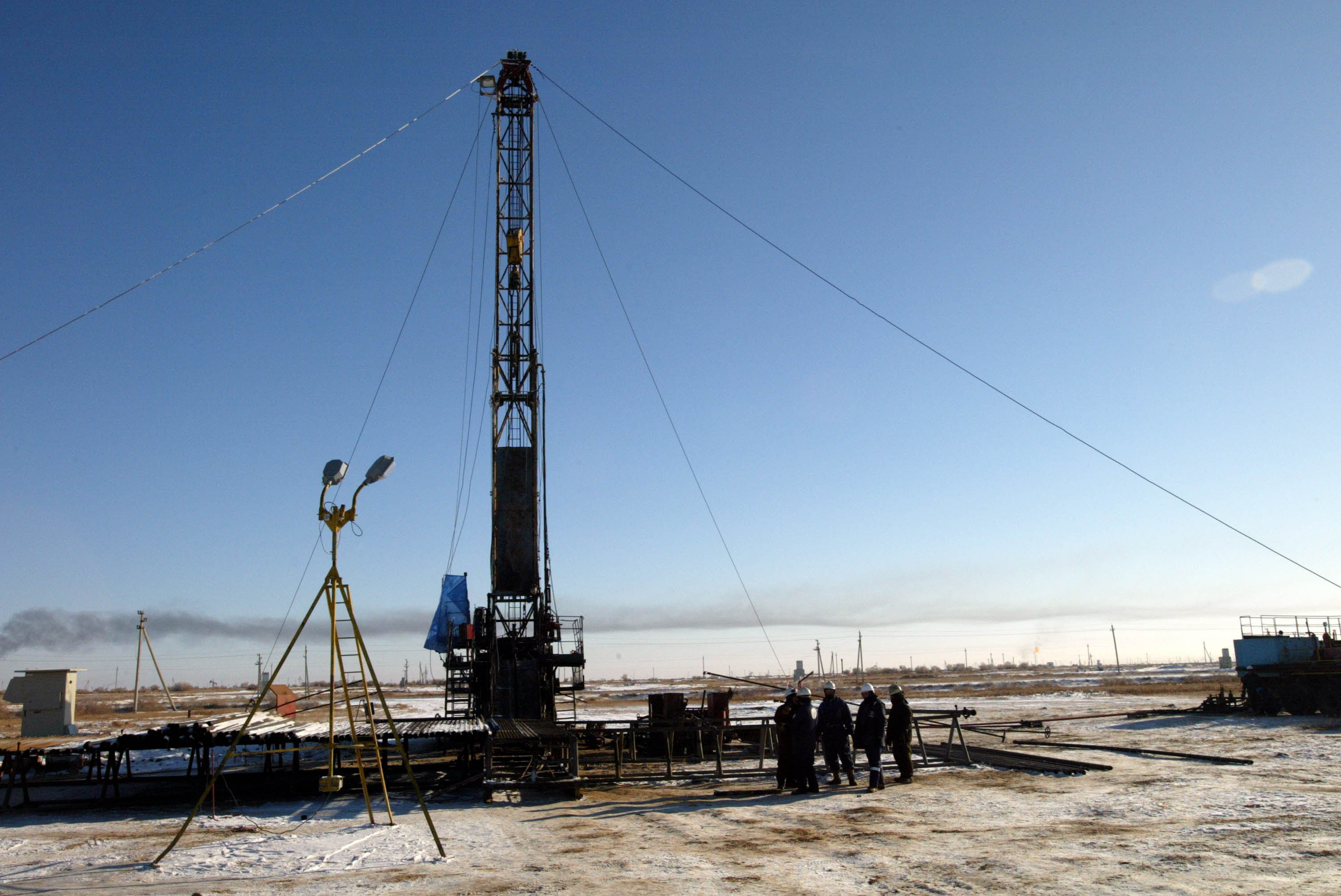 Workers service an oil well in Kyzylorda, Kazakhstan.