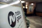 Noble Group Ltd. signage sits on display outside during an investor day in Singapore, on Monday, Aug. 17, 2015. Noble pledged to increase operating profit to more than $2 billion in the next three to five years as Asia's largest commodity trader sought to reassure investors about its long-term prospects.