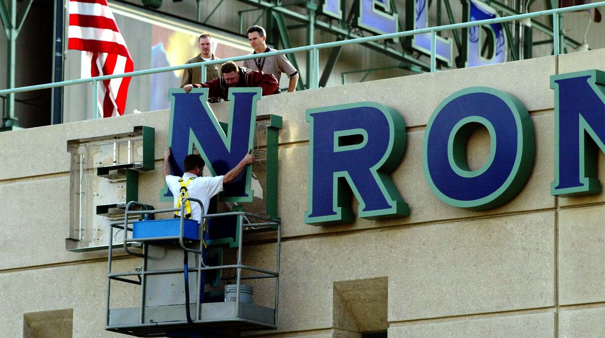 Workers taking down Enron building sign