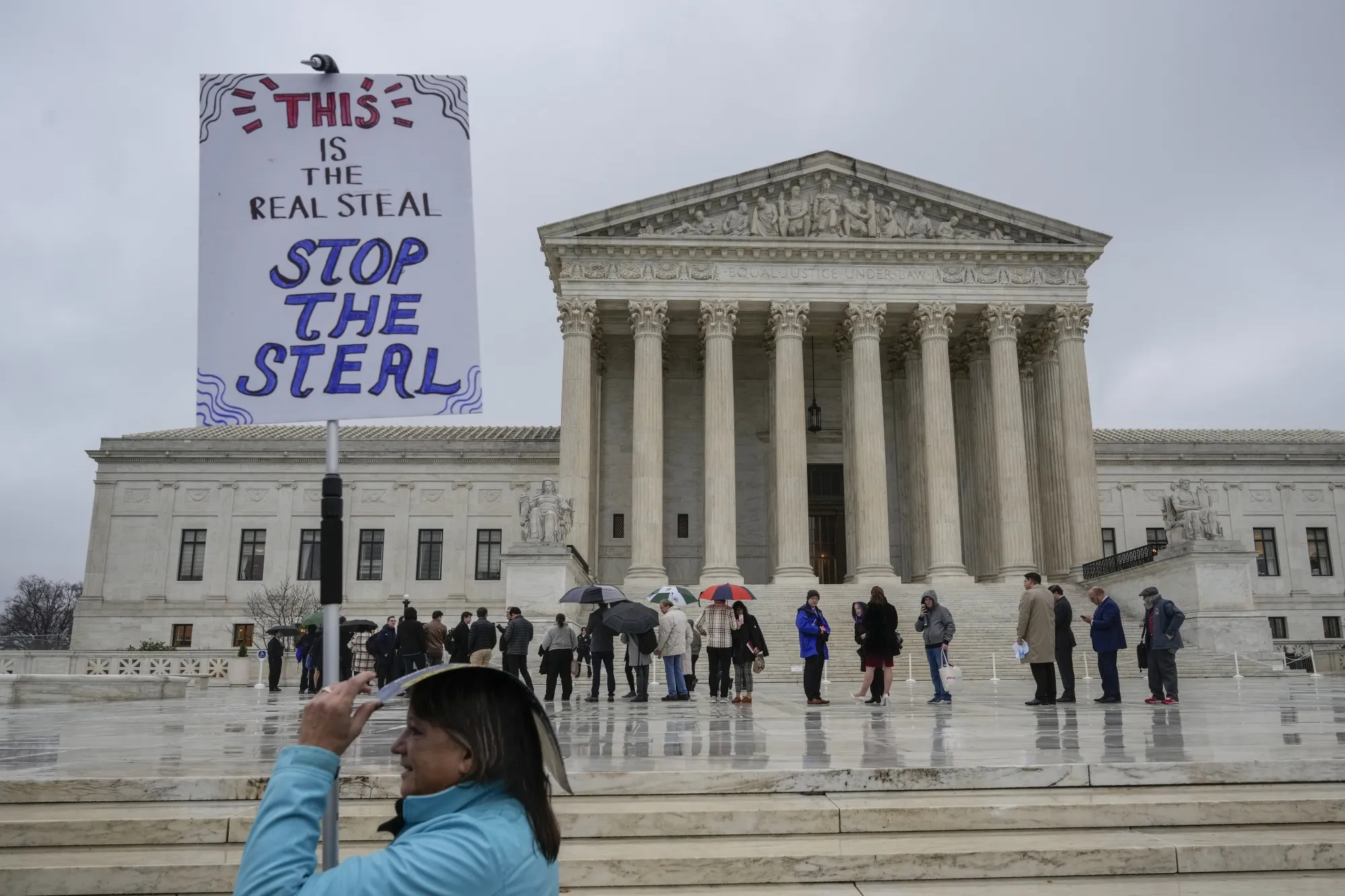 People wait in line outside the US&nbsp;Supreme Court to hear oral arguments in the Moore v. Harper case on December 7, 2022.