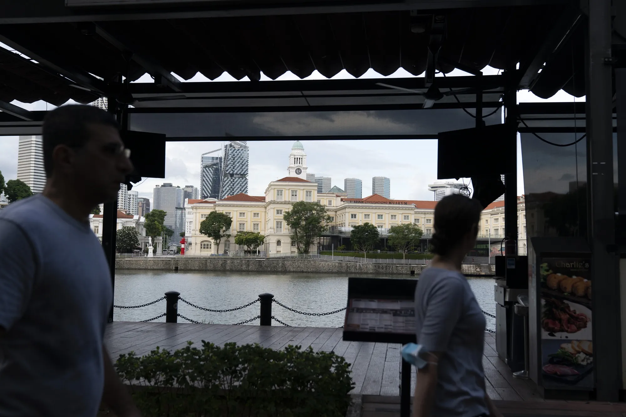 People exercise at Boat Quay in the business district of Singapore on June 14.