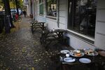 Plates on a vacant restaurant terrace table in the Neukoelln district of Berlin, Germany, on Thursday, Oct. 22, 2020. 