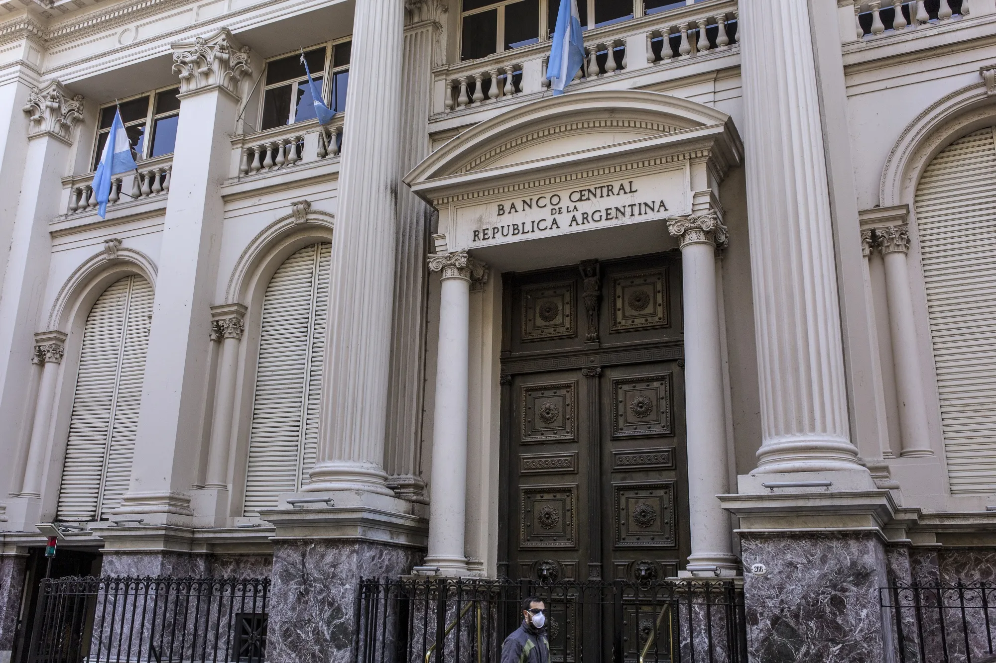 A pedestrian wearing a protective mask walks past the Central Bank of Argentina in&nbsp;Buenos Aires, Argentina, on&nbsp;April 30.