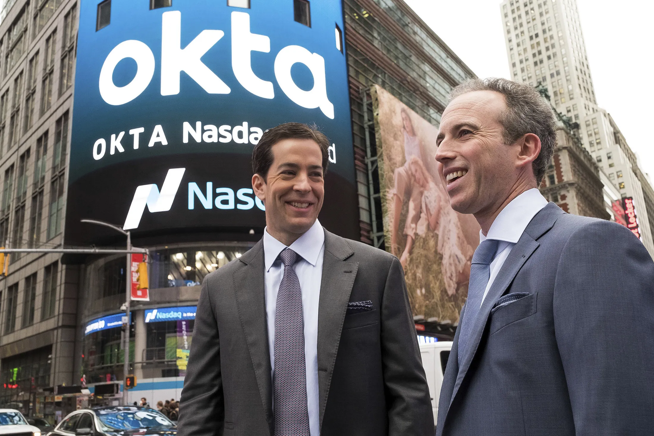Okta co-founders Todd McKinnon, left, and Frederic Kerrest stand in Times Square after the company’s IPO on April 7, 2017 in New York.