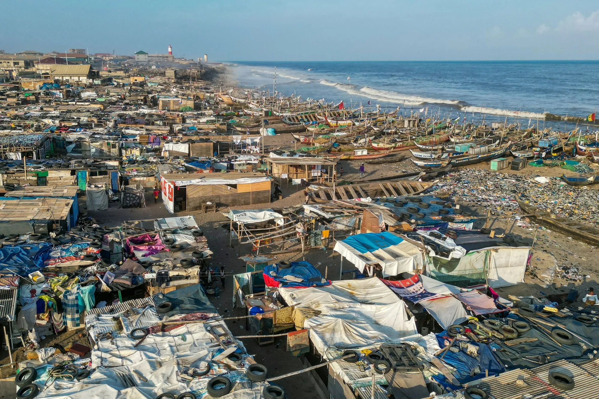 Plastic waste and garbage in front of informal housing and buildings on the shoreline of Jamestown beach in Accra, Ghana, in 2022.