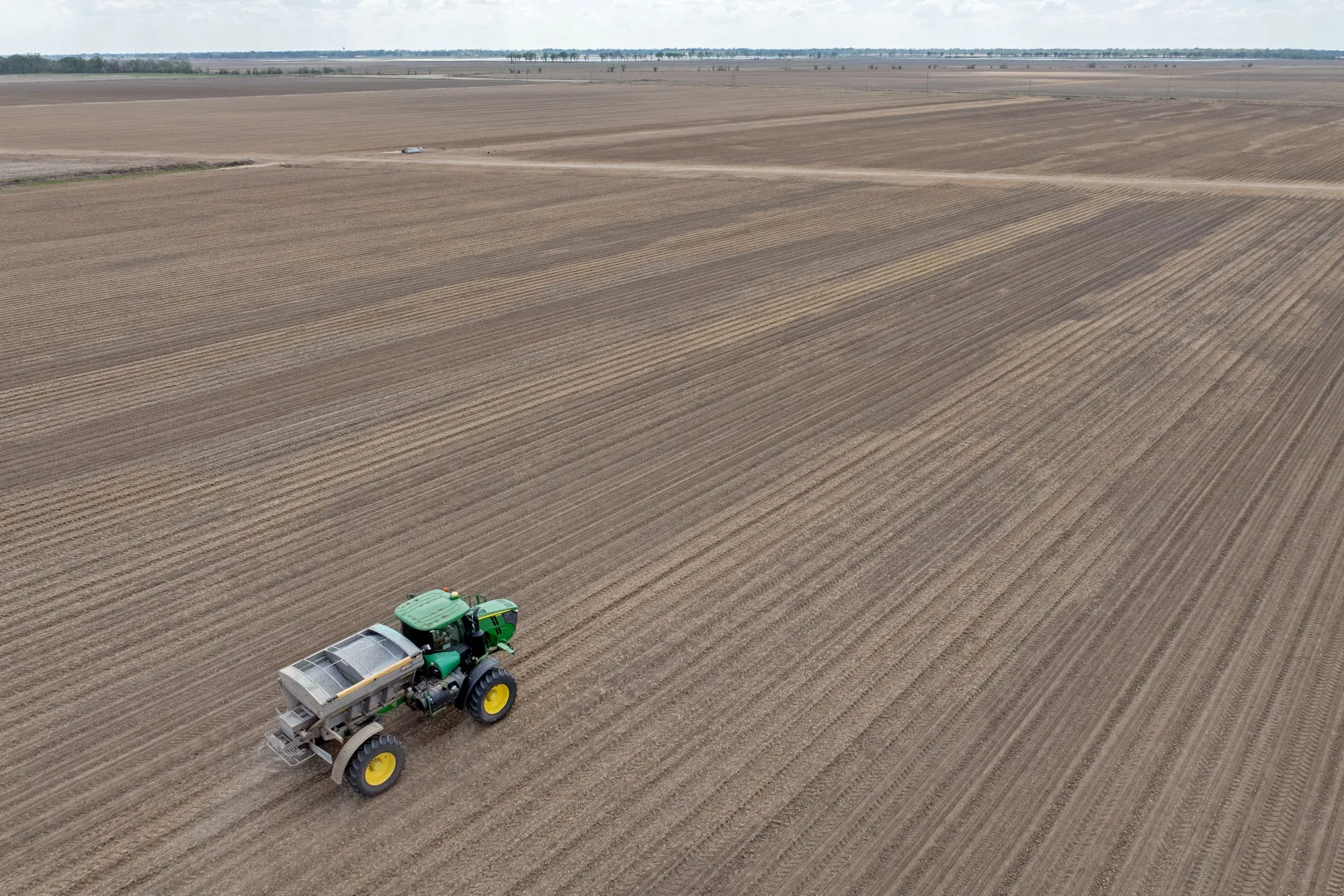 A mixture of urea and potash fertilizer is spread onto a corn field at a farm in Ruleville, Mississippi, US.