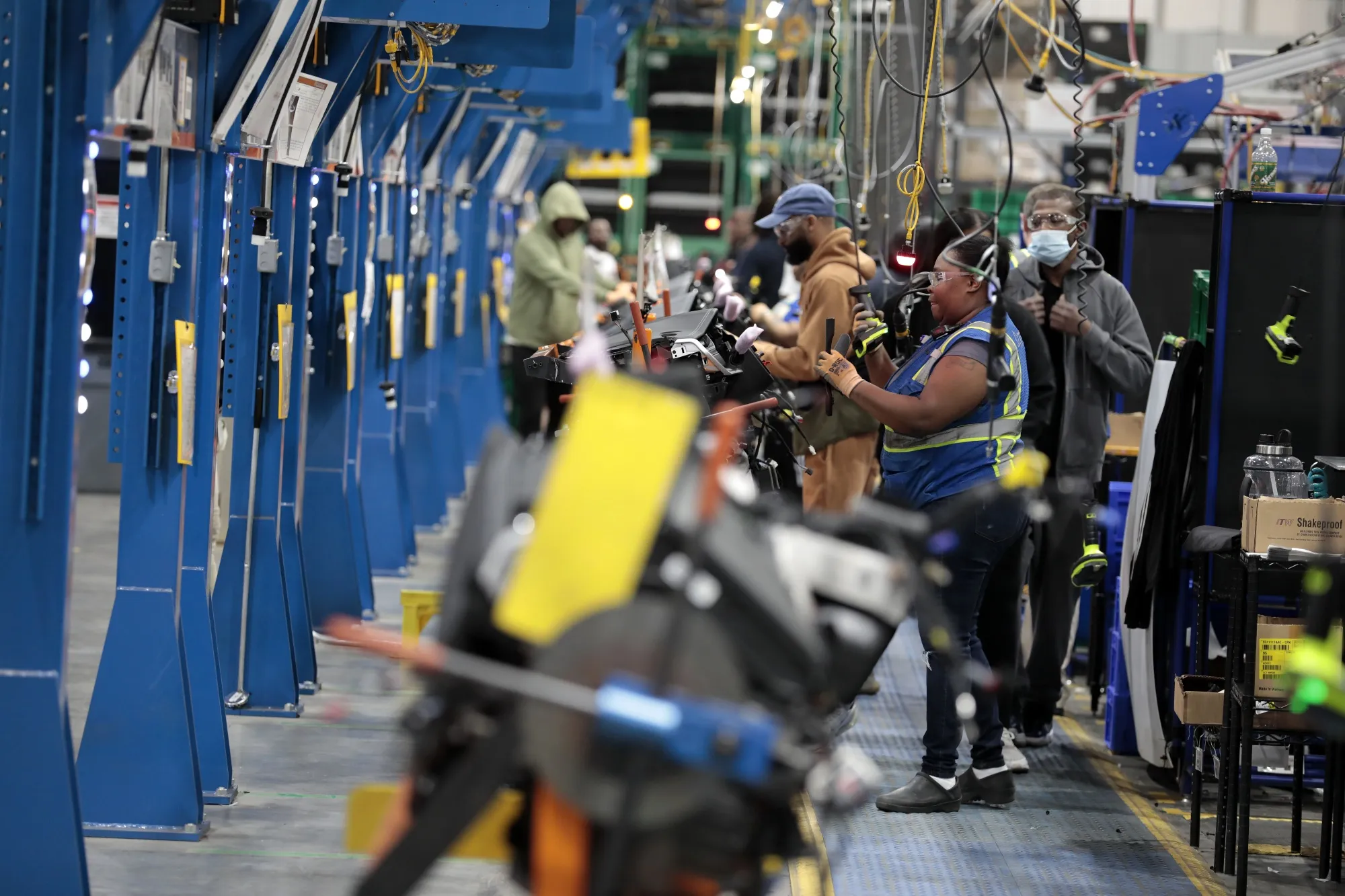 Employees work at a manufacturing facility in Detroit.