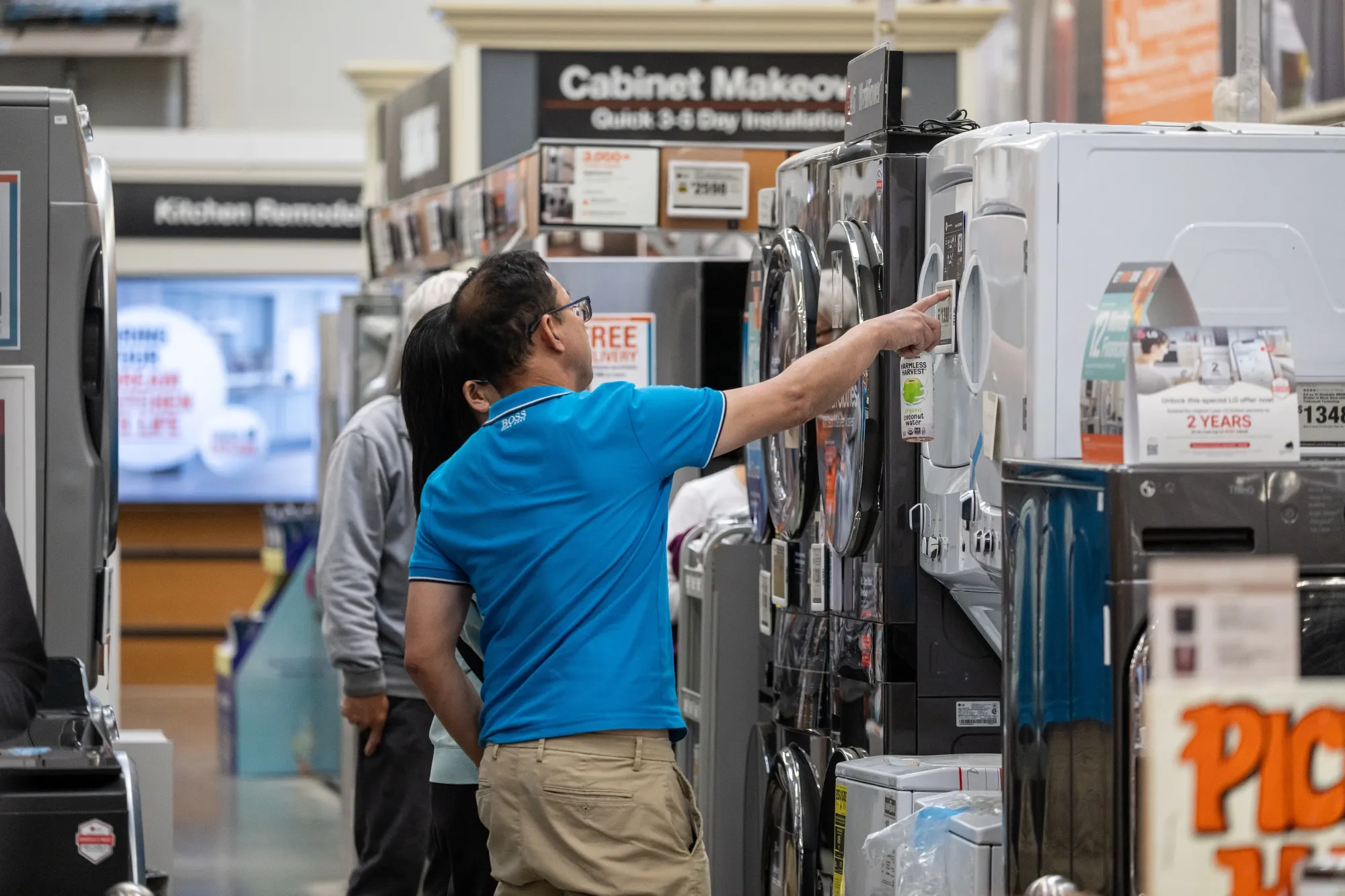Shoppers browse washer and dryer appliances displayed for sale inside a Home Depot store in Colma, California.