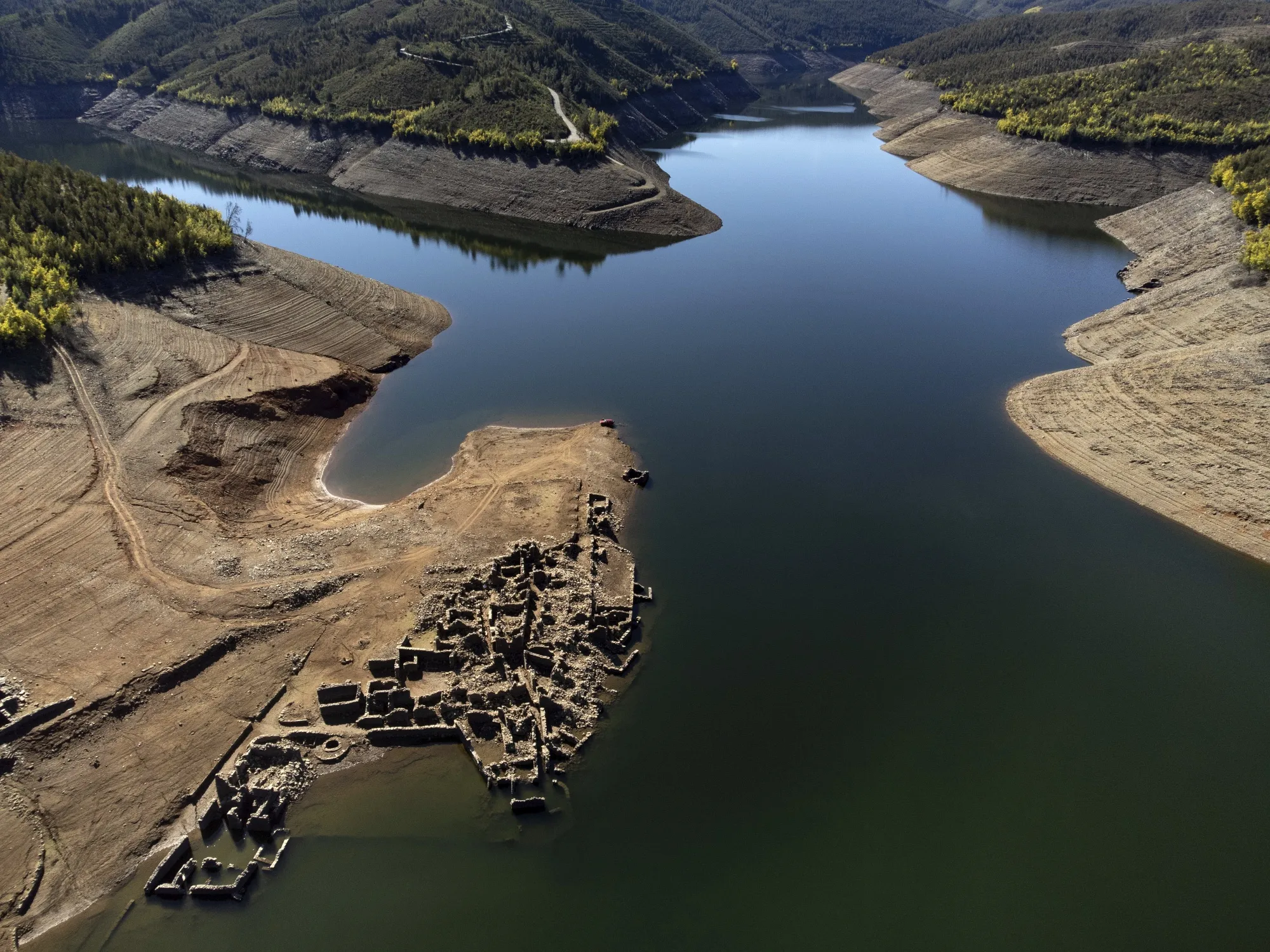 The ruins of the old village of Vilar, submerged since 1954 when a hydropower dam flooded the valley, rise above the waters of the Zezere River due to drought, near Pampilhosa da Serra in central Portugal, Thursday, Feb. 17, 2022. Portugal's winter drought is getting worse, with the national weather agency reporting Monday that 91% of the country is enduring "severe" or "extreme" drought conditions. (AP Photo/Sergio Azenha, File)