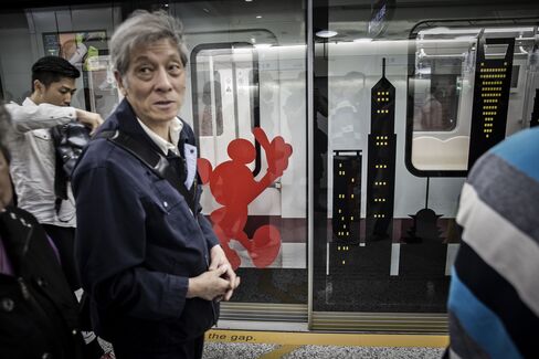 Passengers wait for a train at the Disney subway station on May 7.