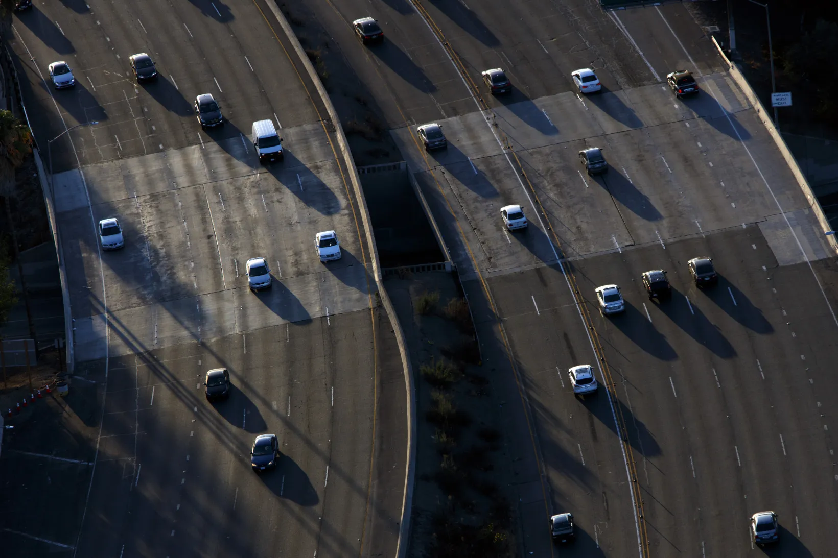 Cars move along during rush hour traffic on the US 101 Freeway in this aerial photograph taken over the Sherman Oaks neighborhood of Los Angeles.